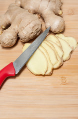 Ginger root on a bamboo chopping block