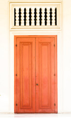 Vintage wooden door on white wall.