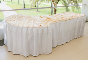 Table decorated with white table cloth.