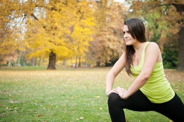 Woman performs stretching before jogging