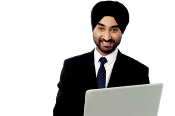 Happy businessman using is laptop computer