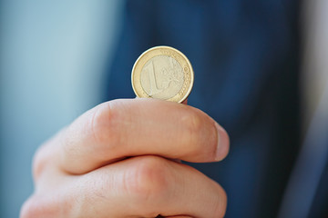 hand with euro coin