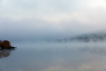 Portrait of a quiet foggy lake
