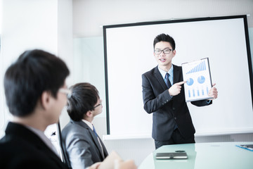 businessman giving a presentation to his colleagues
