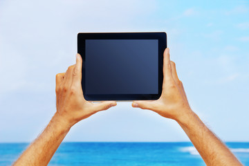 hands holding a tablet