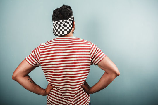 Young Man In Striped Shirt And Checkered Hat