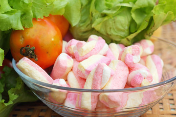 Vegetables salad, tomato and pink marshmallows.