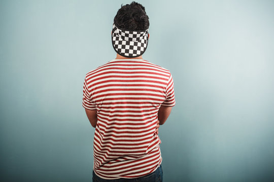 Young man in striped shirt and checkered hat