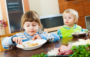 siblings together eating food