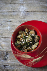 roasted japanese turnips with leaves and seeds on red bowl