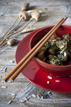 roasted japanese turnips with leaves and seeds on red bowl