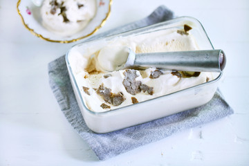 Fototapeta na wymiar Ice cream scoop in ice box with caramel ice cream and truffles