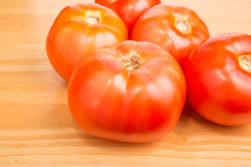 Red Ripe Tomatoes on Wood Cutting Board