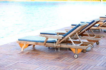 Lounge sunbeds near swimming pool