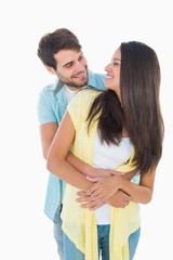 Happy casual couple smiling at each other