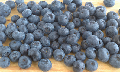 the berries of blueberry scattered on a cutting board