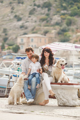 Happy family with dogs on the Quay in the summer
