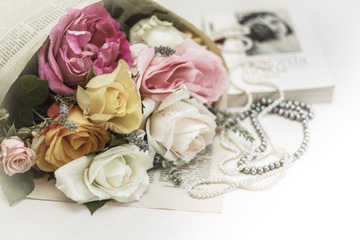 Wedding invitation. Roses with vintage book and pearl necklaces