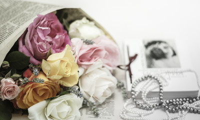 Wedding invitation. Roses with vintage book and pearl necklaces