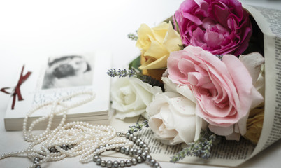 Wedding invitation. Roses with vintage book and pearl necklaces