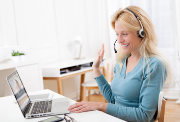 Young attractive woman blonde chatting on laptop