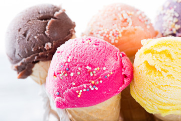 Ice cream scoops on wooden table.