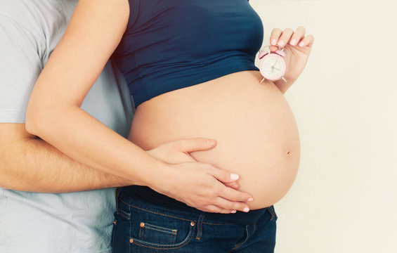 healthy pregnant woman with husband anticipating baby