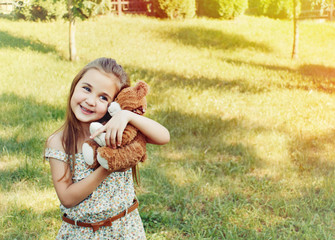happy smiling little girl playing with toy in the kindergarden i