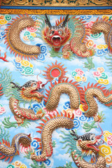 Dragon sculpture on wall in Chinese temple.