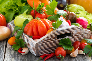 harvest of fresh seasonal vegetables in a wooden box, horizontal