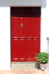red wooden door with knocker