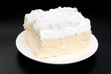 Coconut cake on black background