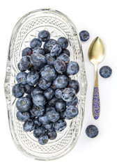 Fresh blueberries in oval glass dessert bowl and spoon