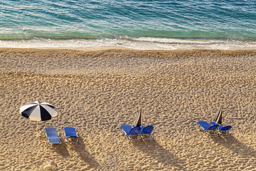 Fototapeta na wymiar chairs and umbrella on a beach