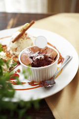 close up chocolate cake with caramel sauce and spoon