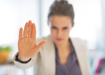 Closeup on business woman in office showing stop gesture