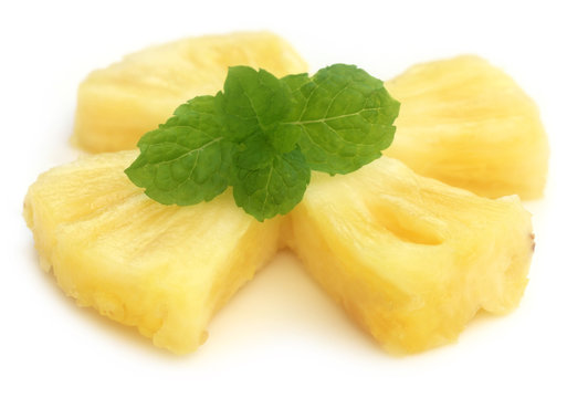 Sliced pineapple with mint leaves