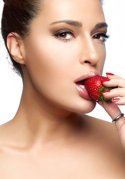 Beautiful Young Woman Eating Strawberry