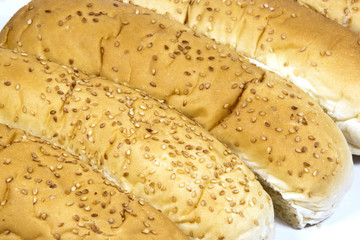 Closeup of Long White Breadrolls Sprinkled with Sesame Seeds