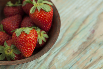 Fresh strawberries ona wooden bowl