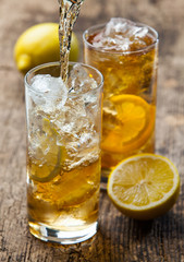 Pouring iced tea with lemon