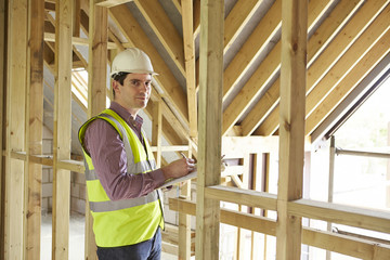 Fototapeta premium Building Inspector Looking At New Property