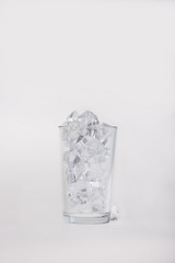 Empty glass filled with ice cubes