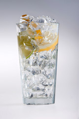 Glass Of Drink With Ice Cubes And Fruits On White