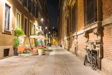 Fototapeta na wymiar Old street in Milan at night, Italy
