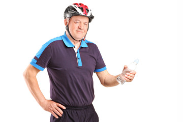 Mature cyclist holding a bottle