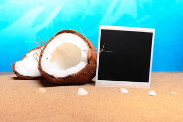chopped coconut and photoframe on the sand