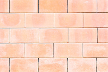 Square orange brick wall background.