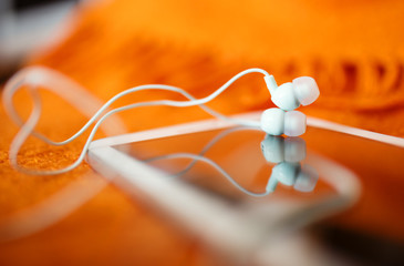 White earphones and tablet pc, close up photo, small dof
