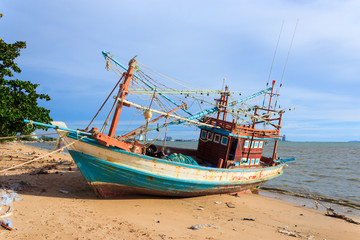 Fototapeta na wymiar Wooden fishing boat on the beach